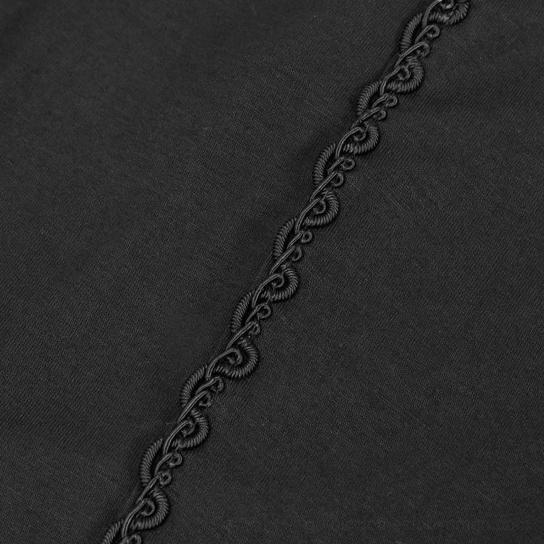 Black braided decorative side trim on stretchy gothic leggings fabric showing texture and construction