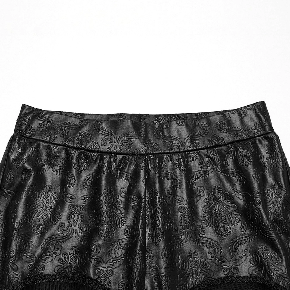 Close-up detail of gothic leggings waistband with embossed paisley texture, top-down view