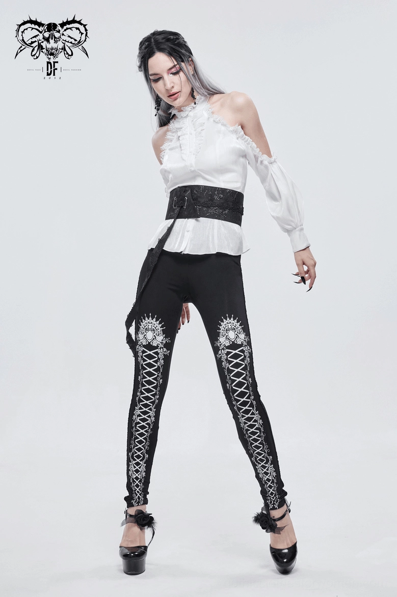 Black gothic rose ornamental leggings styled with mesh top and chain accessories for evening wear