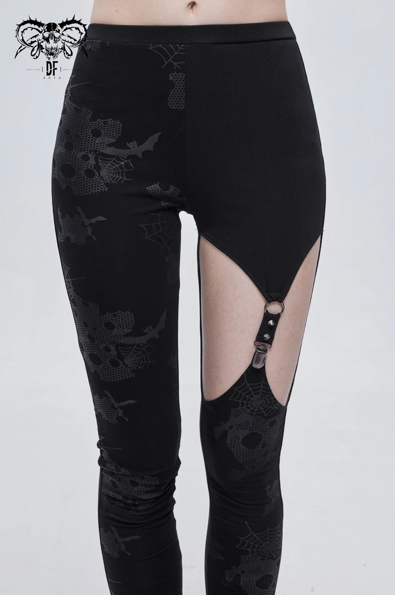 Close-up of asymmetrical black gothic leggings showing horror-inspired print patterns and fabric texture quality