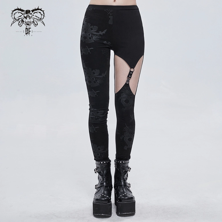 Asymmetrical black gothic leggings worn by model full front view showing metal buckle thigh cutout and horror prints