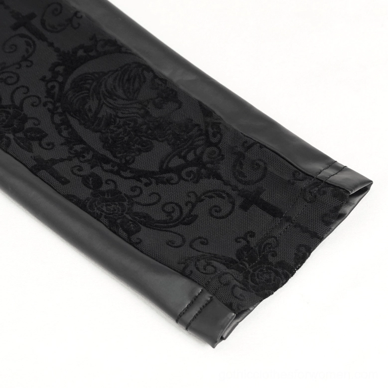 Close-up detail of black gothic leggings leg panel showing floral lace and faux leather trim