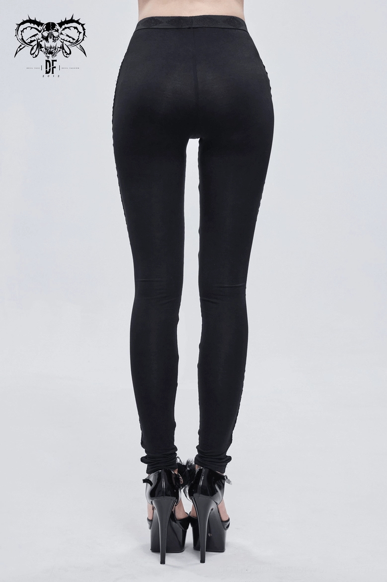 Gothic leggings with lace-up ornamental details styled with leather jacket and platform boots