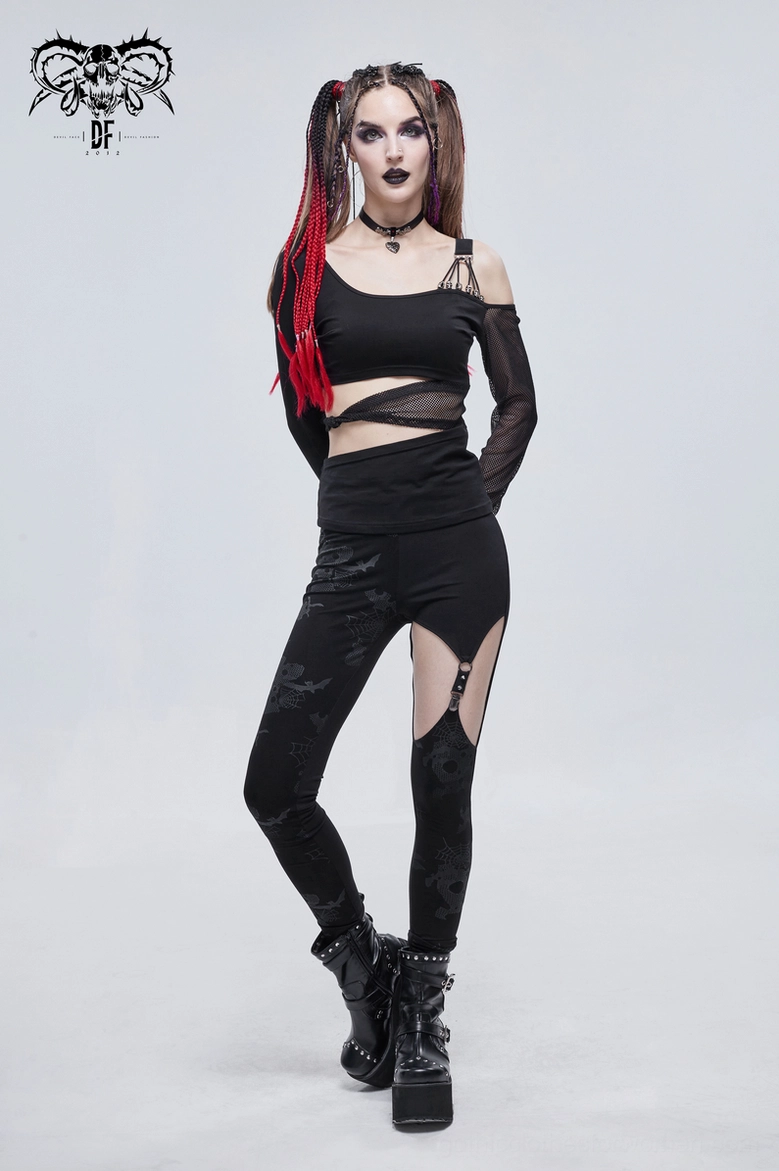 Close detail of metal buckle fastener and spike studs on gothic leggings thigh cutout showing punk hardware aesthetic