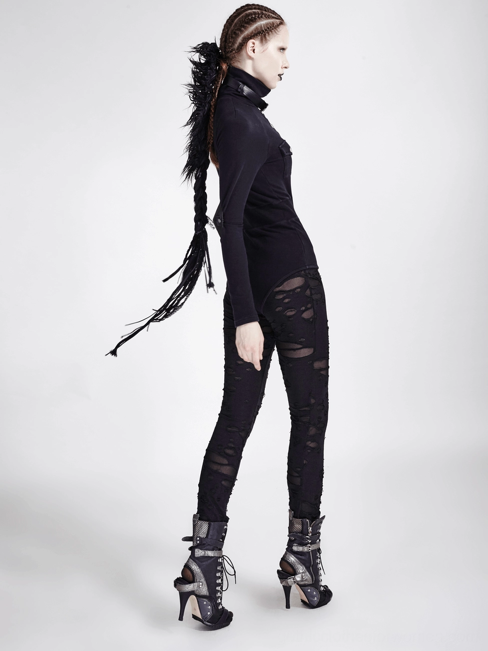 Close-up detail of strategically placed rips and mesh panels on black gothic leggings