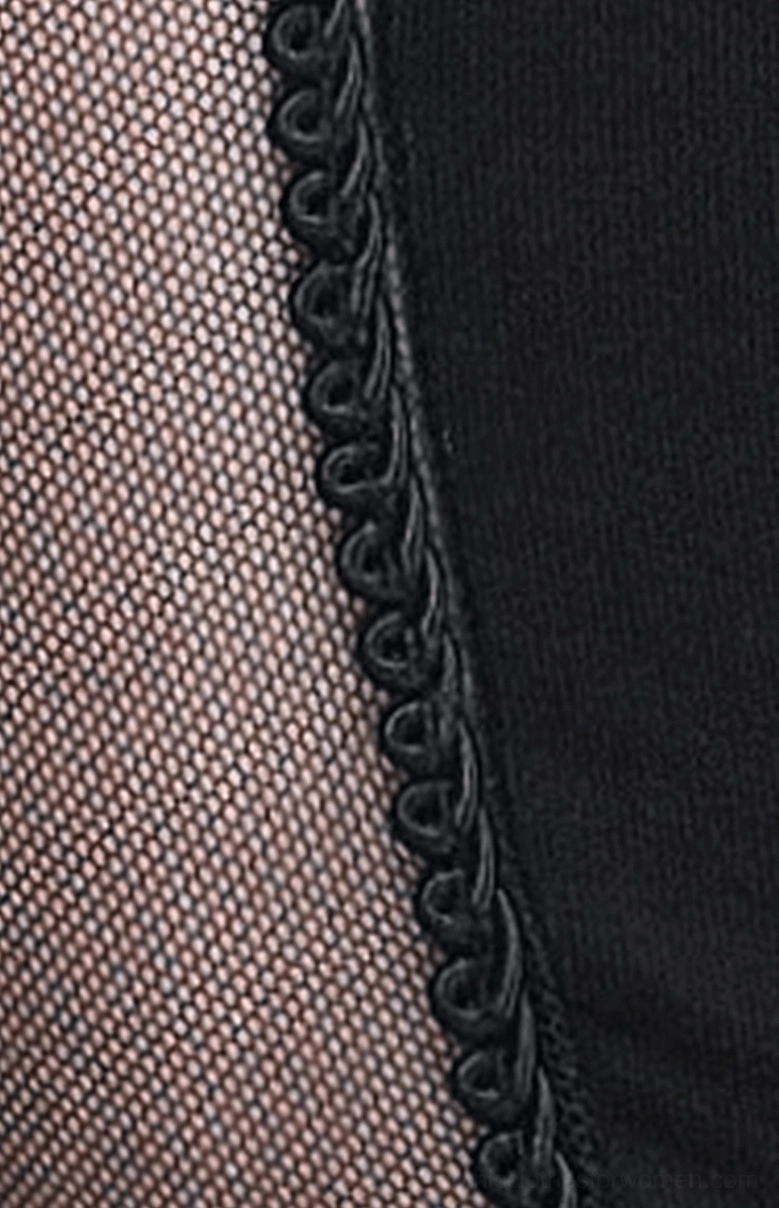 Seam and fabric detail of gothic leggings showing braided black stitch trim where mesh and solid black fabric panels join