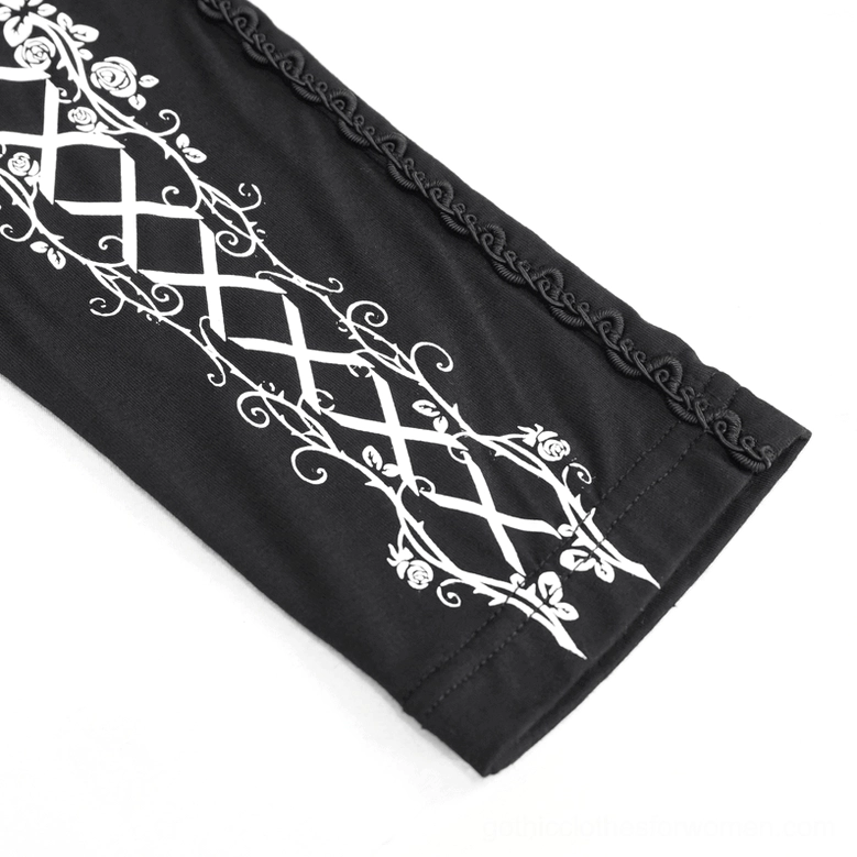 Detailed close-up of black gothic leggings with white lace-up rose prints and braided side trim