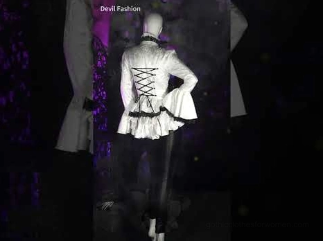 Gothic stage outfit featuring lace-up back blouse paired with black lace-up leggings on mannequin dark lighting