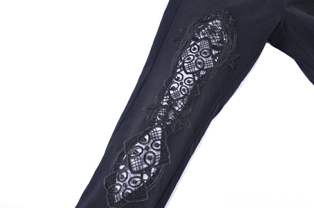 Close-up side view of thigh lace panel insert on black gothic leggings showing intricate vintage floral geometric lace pattern detail