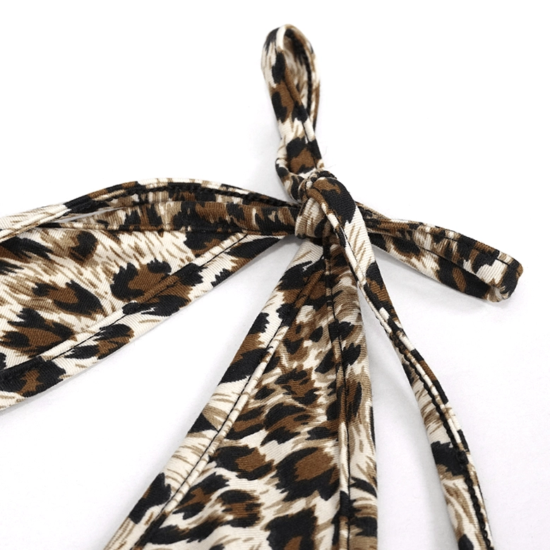 Close-up detail of leopard print bikini strap, showcasing wide tie straps and knotted bow closure with animal print pattern