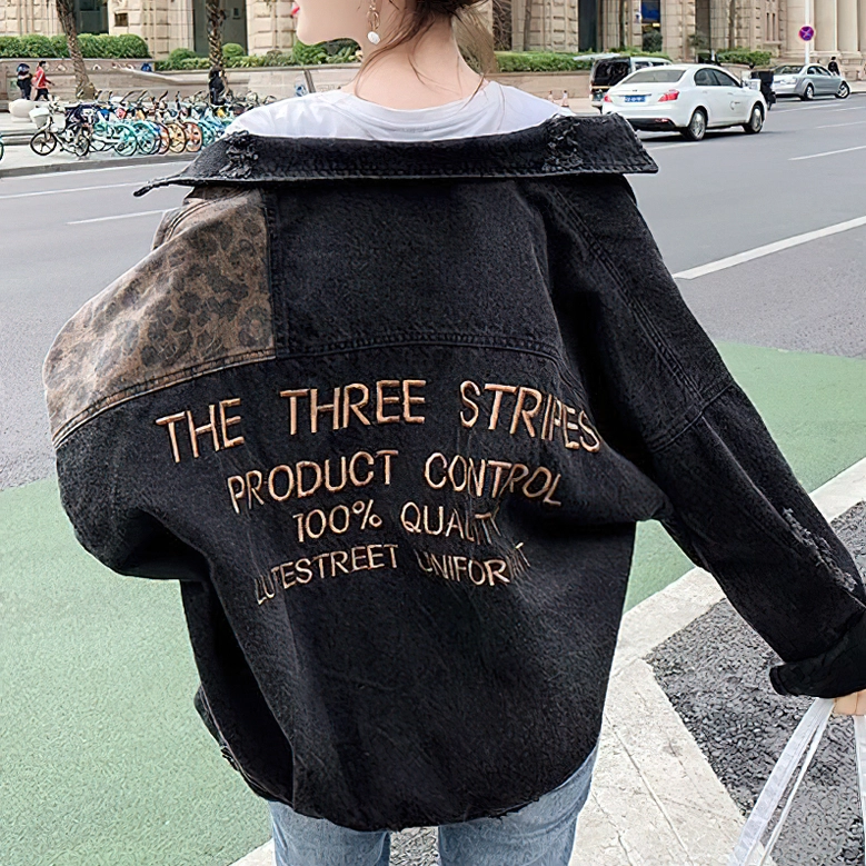 Alternative women's denim jacket back view on model, showing oversized fit and embroidered leopard details from behind