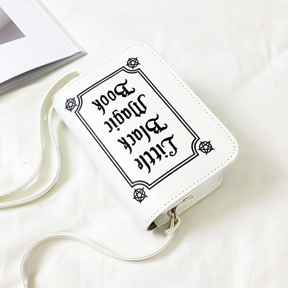 White gothic letter crossbody bag upside-down front view with reversed symbolic text print and modern goth aesthetic