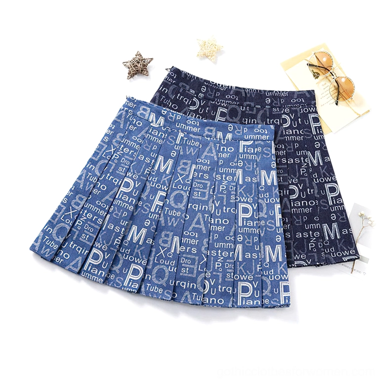 Pair of typography denim pleated skirts side-by-side flat lay with gothic accessories, navy and blue variations
