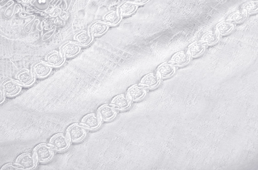 Close-up embroidered lace ribbon trim detail - scalloped edge, twisted cord detail on gothic lolita dress