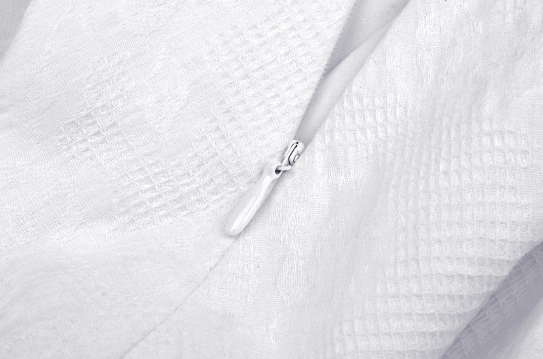 Close-up side zipper closure detail - hidden zipper, plain woven fabric construction on gothic lolita dress
