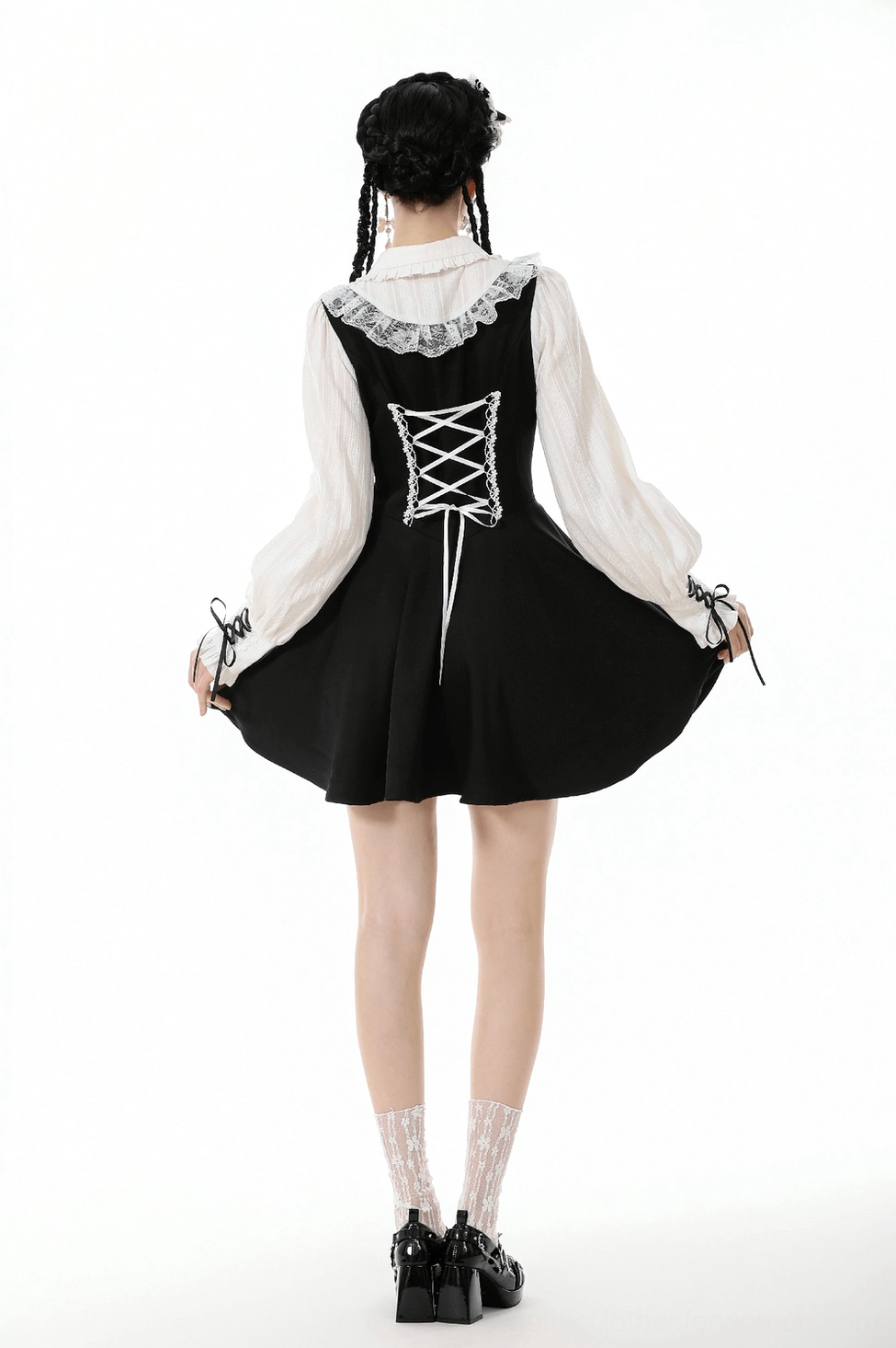 Gothic lolita dress waist and hem detail showing a-line mini skirt cut, ribbon accents, and layered structure