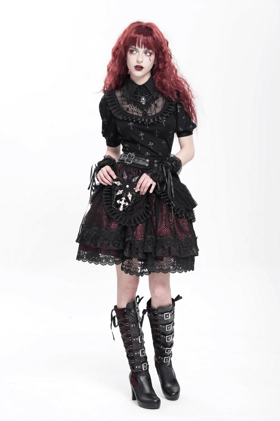 Full gothic lolita outfit styling featuring red-haired model in black lace dress with matching coffin cross brooch, buckle boots, and alternative accessories