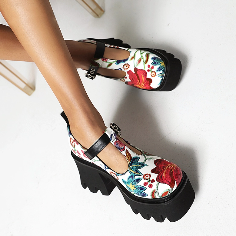 Close-up detail of gothic floral platform Mary Jane pump showing T-strap buckle, floral print pattern and lug sole texture