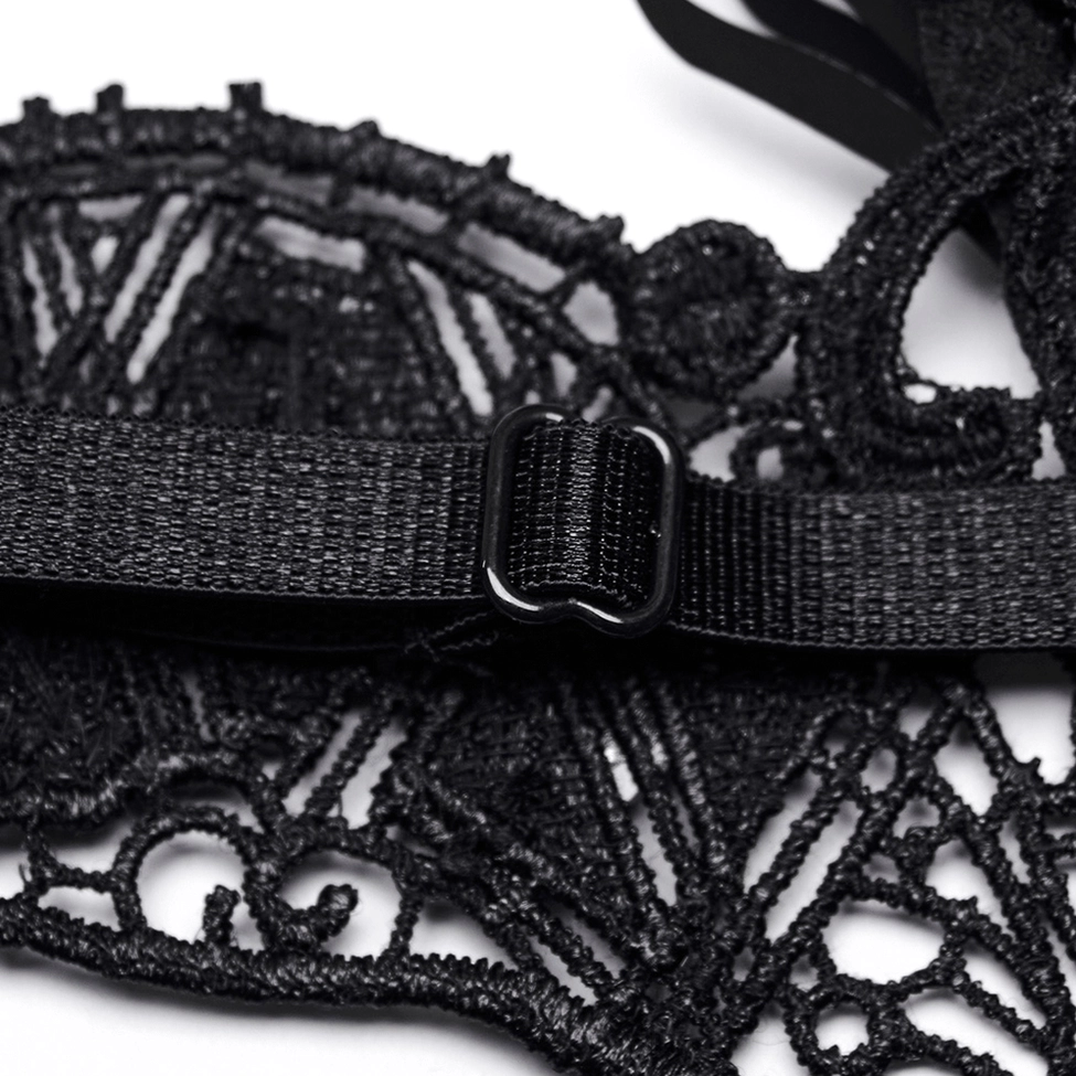 Close-up of gothic mask lace base and metal buckle fastener showing intricate carved lace texture