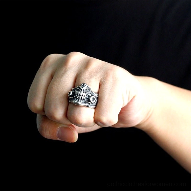 Antique silver gas mask ring worn on clenched fist displaying bold gothic aesthetic
