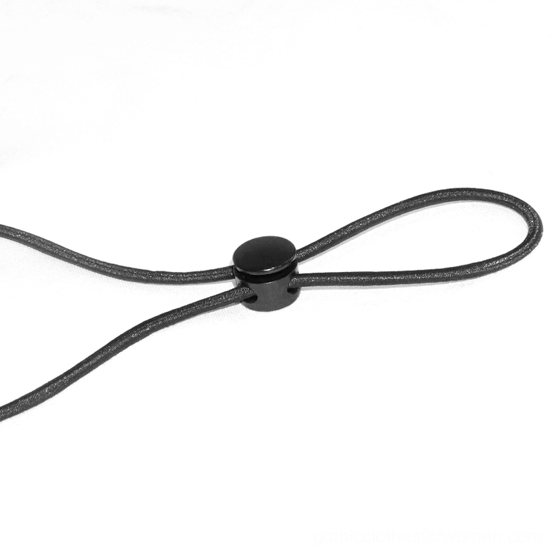 Close-up detail of black gothic mask showing ear strap attachment point and decorative accents