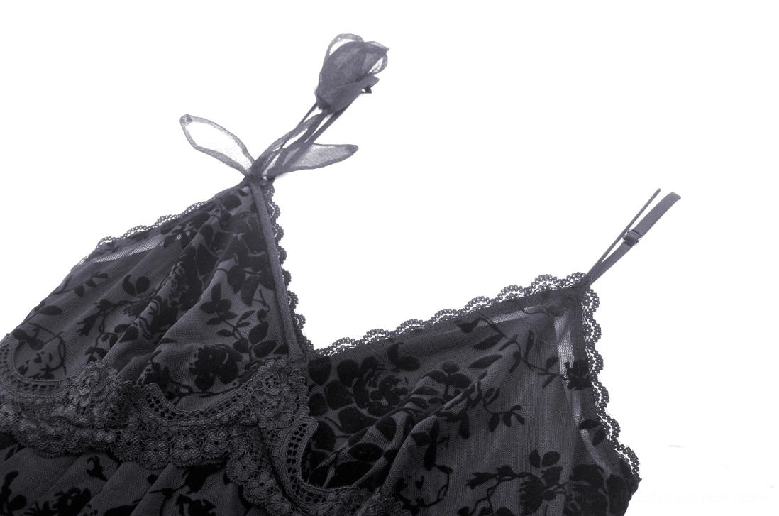 Close-up of black gothic dress neckline with scalloped lace trim and rose ornament detail