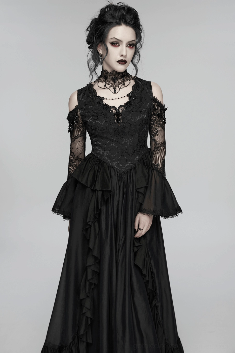 Black gothic lace maxi dress skirt detail, showing tiered ruffle layers, flowing movement, hem embellishment, and floor-length construction