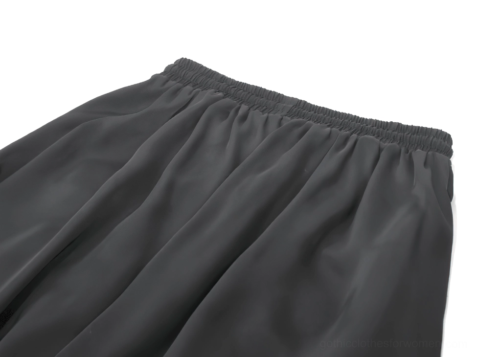 Black gothic maxi skirt fabric close-up showing elastic waistband detail and smooth satin material texture