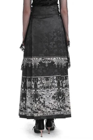 Black gothic maxi skirt rear view worn by female model displaying high-waisted design with embroidered trim bands and flowing silhouette in studio setting