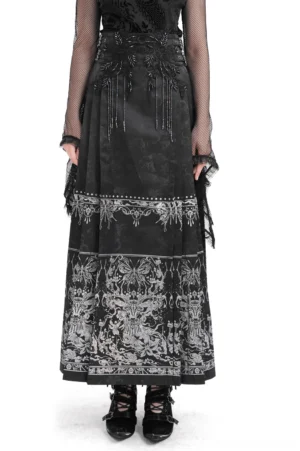 Black jacquard gothic maxi skirt with silver embroidery worn by female model in front full-body view showing intricate beaded trims and silver details against white studio background