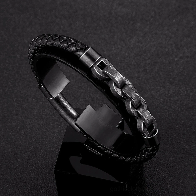 Premium black leather braided and gunmetal stainless steel chain gothic bracelet on display stand, close-up studio shot