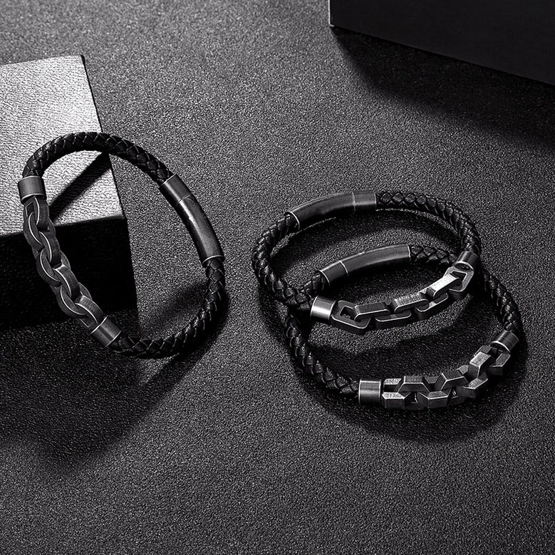Three styles of men's black leather and gunmetal chain gothic bracelets on dark background, collection shot