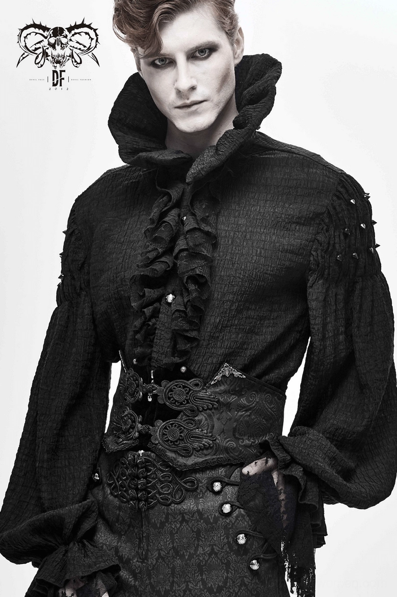 Male model wearing black gothic corset belt with ruffled collar shirt, half body front portrait view