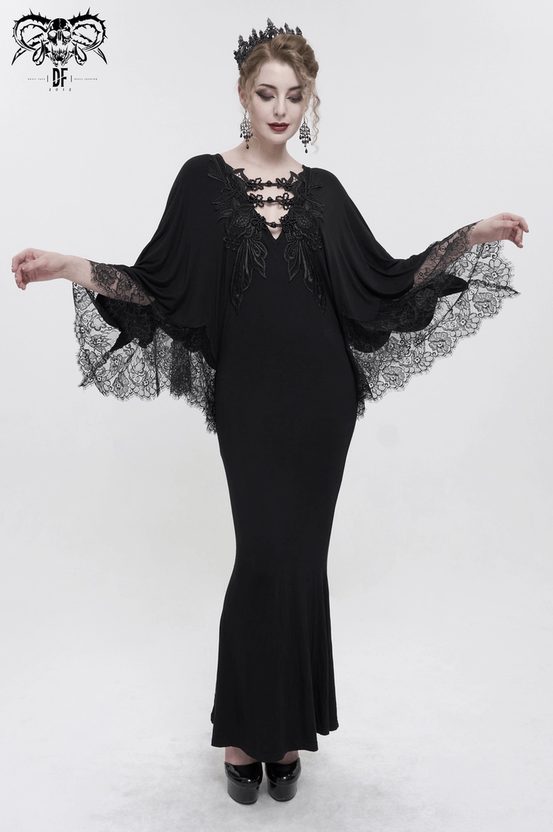 Full-length detail of black gothic mermaid dress hem, showcasing dramatic fishtail silhouette and form-fitting design