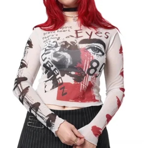 Gothic mesh crop top with graffiti print and long sleeves worn by model with red hair, front view showcasing sheer mesh and retro artwork design