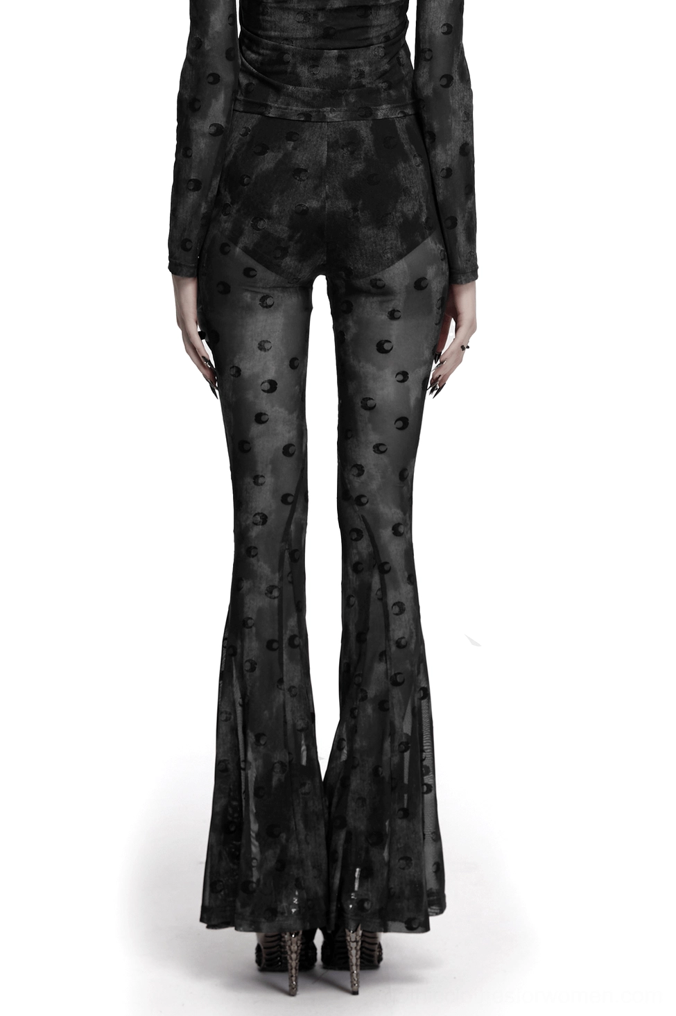 Rear view of crescent moon mesh gothic pants on model showing flared leg and flowing silhouette against white background
