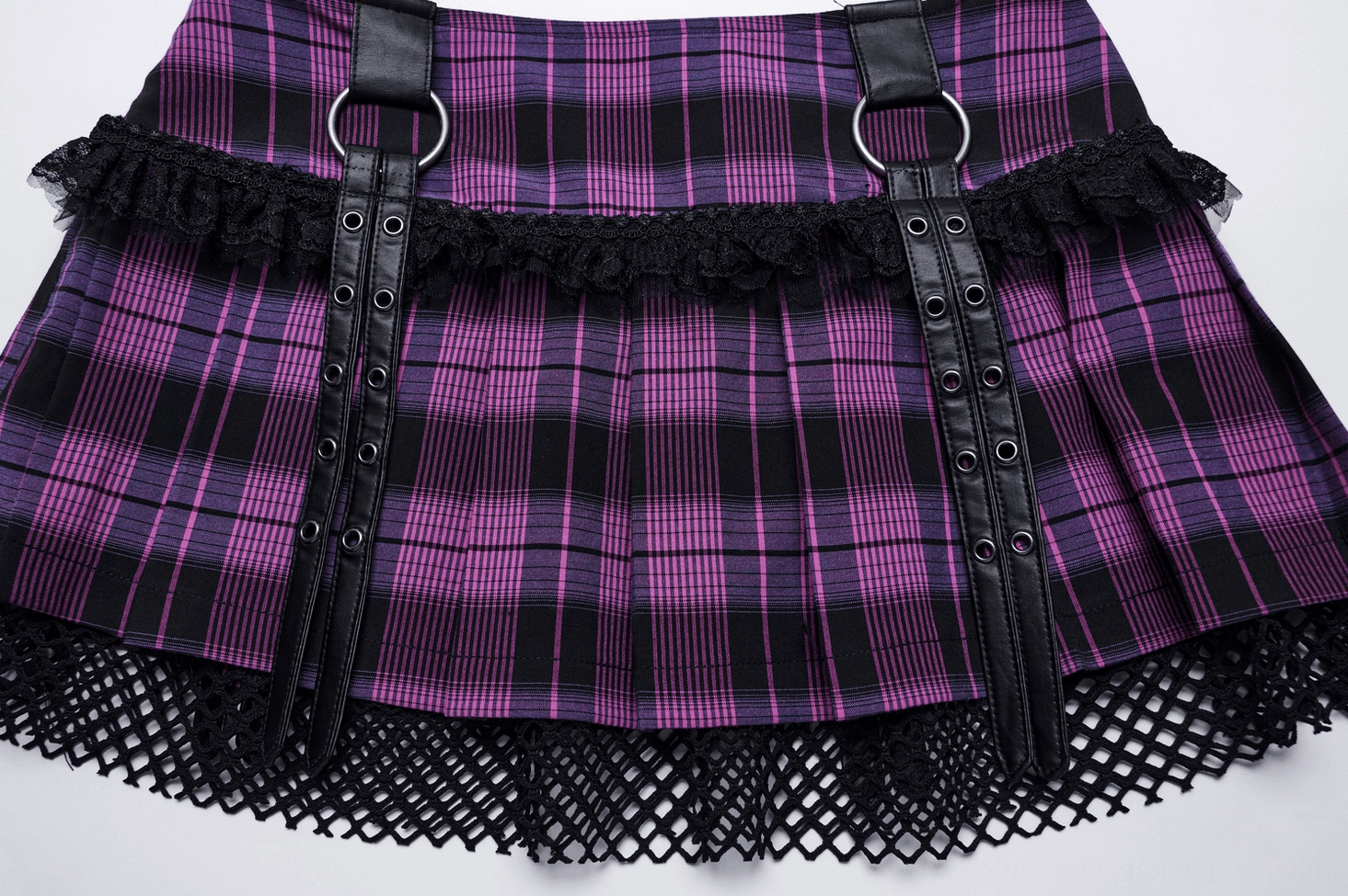 Close-up texture detail of purple gothic mesh mini skirt showcasing yarn-dyed pleated fabric and mesh layer composition
