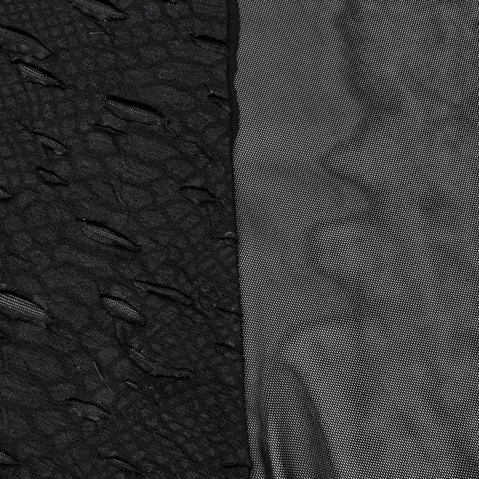Black gothic tattered mesh pleated dress detail shot showing mesh panel construction, layering technique, and distressed fabric treatment characteristic of alternative fashion