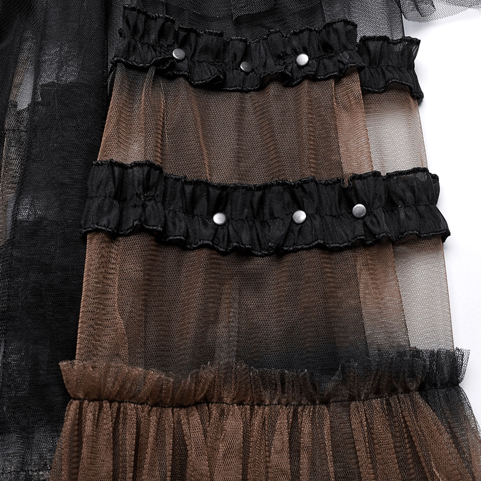 Close-up detail of black mesh skirt ruffles, metal studded black ruffle trim with ombre brown-black sheer tulle layering