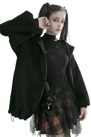 Side profile view of black and orange plaid gothic mesh skirt showing layered tulle hem and voluminous silhouette with model carrying fuzzy crossbody bag