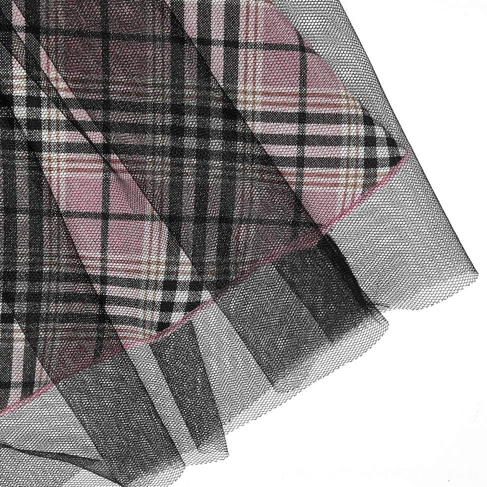 Layered fabric detail showing sheer black tulle overlay on pink tartan plaid gothic mini skirt hem