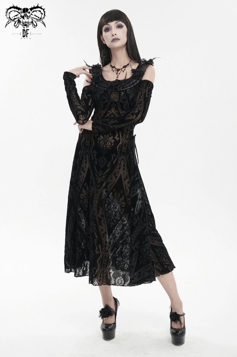 Three-quarter side view of model wearing gothic dress showing arm positioning and long sleeve drape with damask print