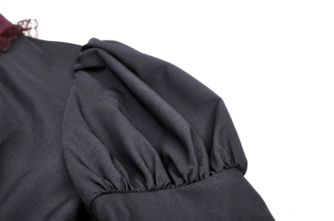 Close-up detail of puff shoulder sleeve design on black gothic mini dress