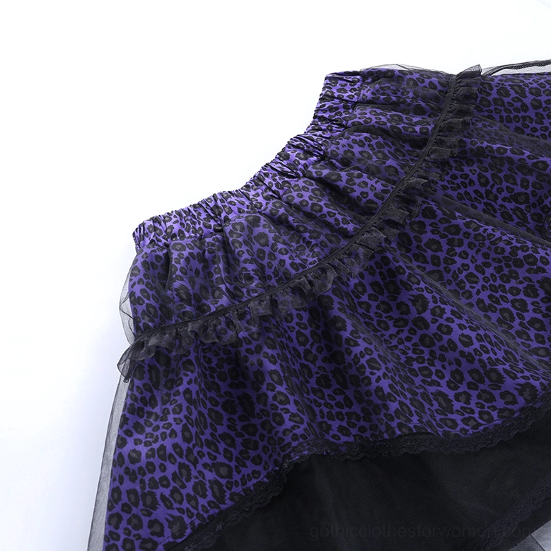 Model wearing purple leopard gothic mini skirt styled with black accessories in dark atmospheric setting