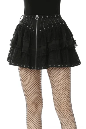 Black heart-laced gothic mini skirt with front zipper and metal grommets, front view on model with fishnet tights