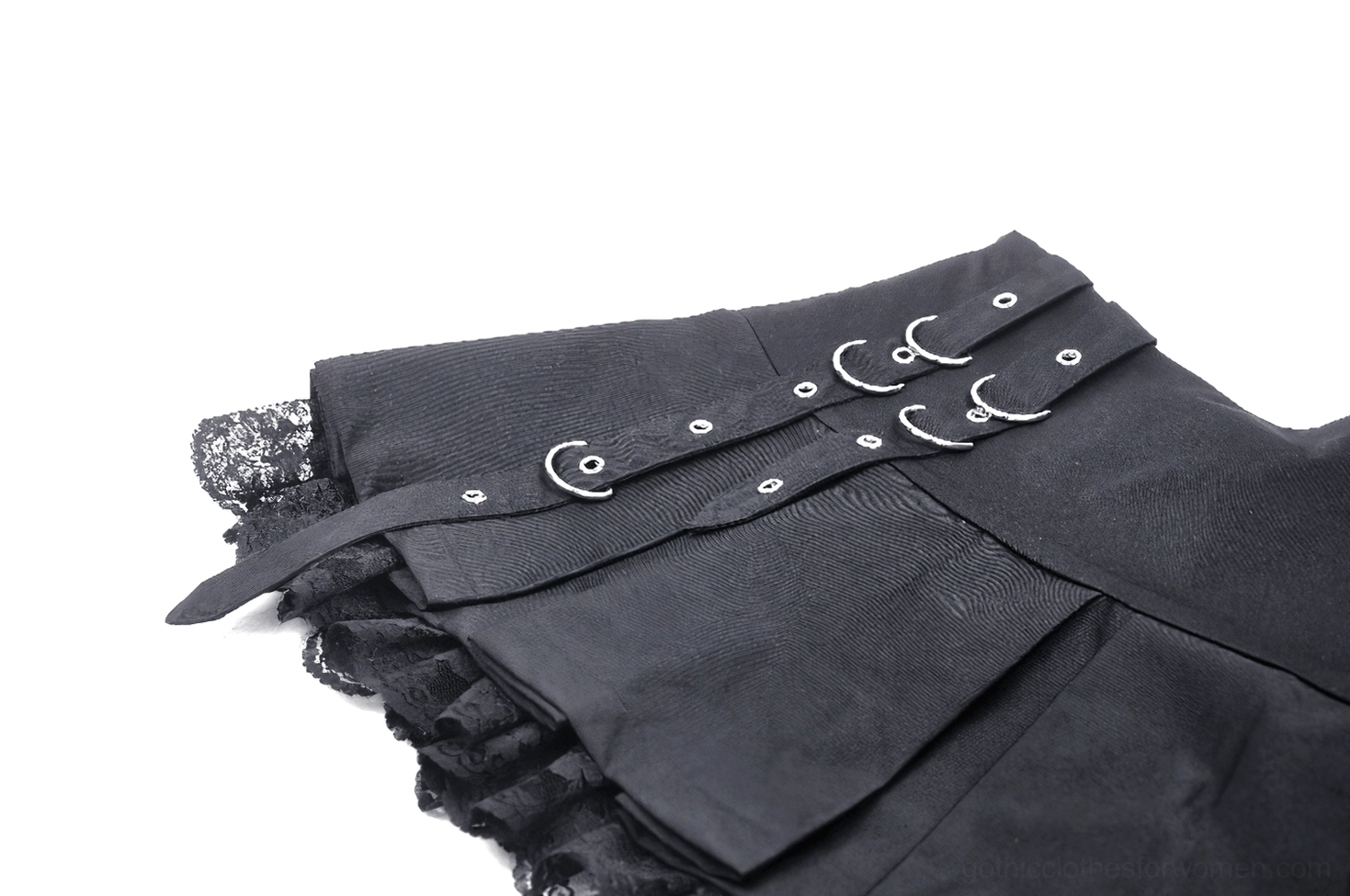 Side angle flat lay of black pleated gothic skirt showing metal hardware, lace trim, and pleated construction