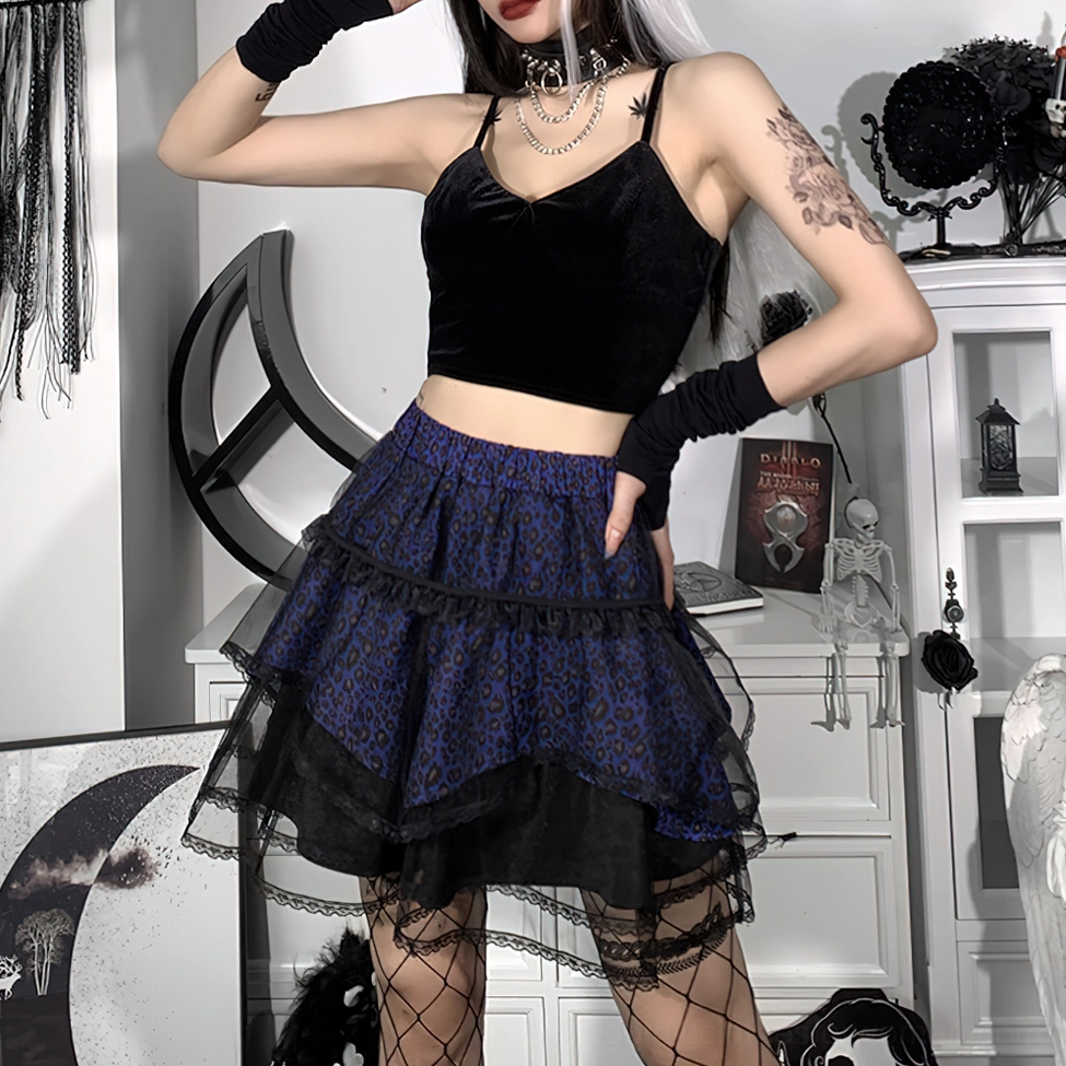 Side three-quarter view of tiered gothic mini skirt showing layered ruffle construction and black tulle trim on model