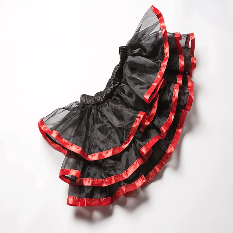 Side view of tiered ruffle mini skirt showing tulle layers, red satin ribbon trim, and elastic waistband construction