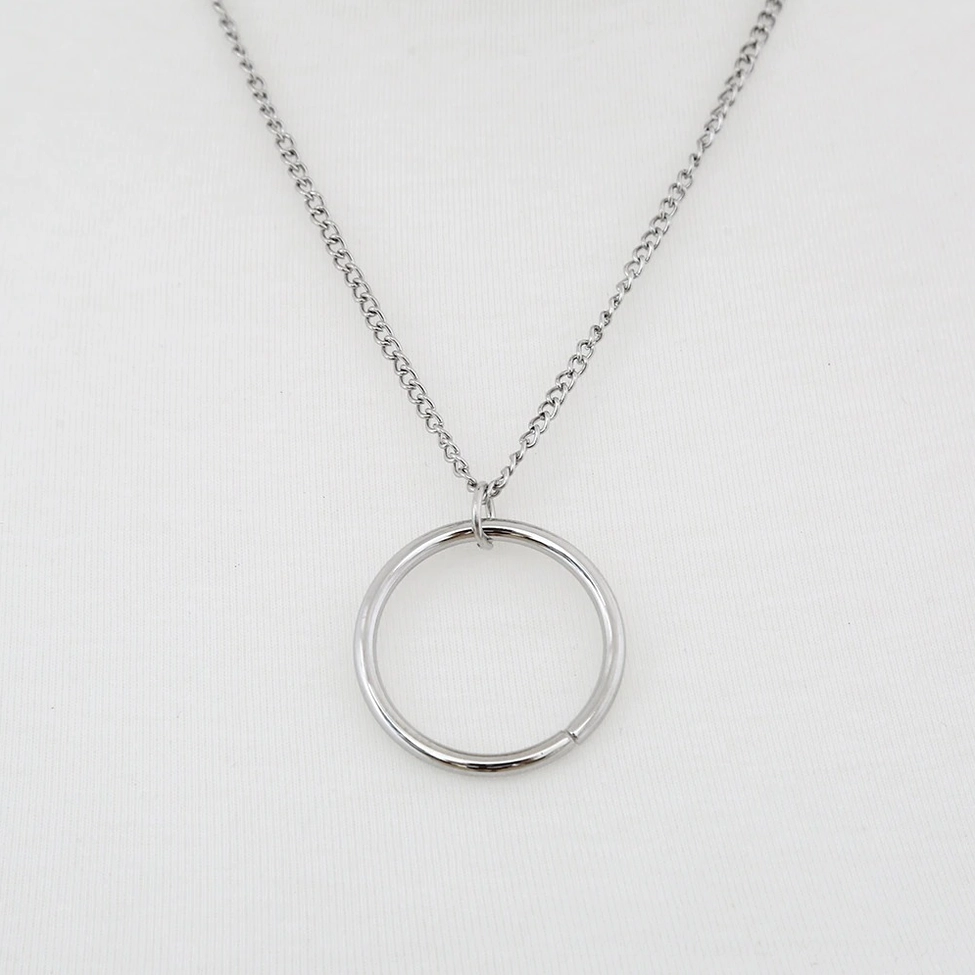 Minimalist silver chain necklace with large round metal charm pendant and thin link chain design