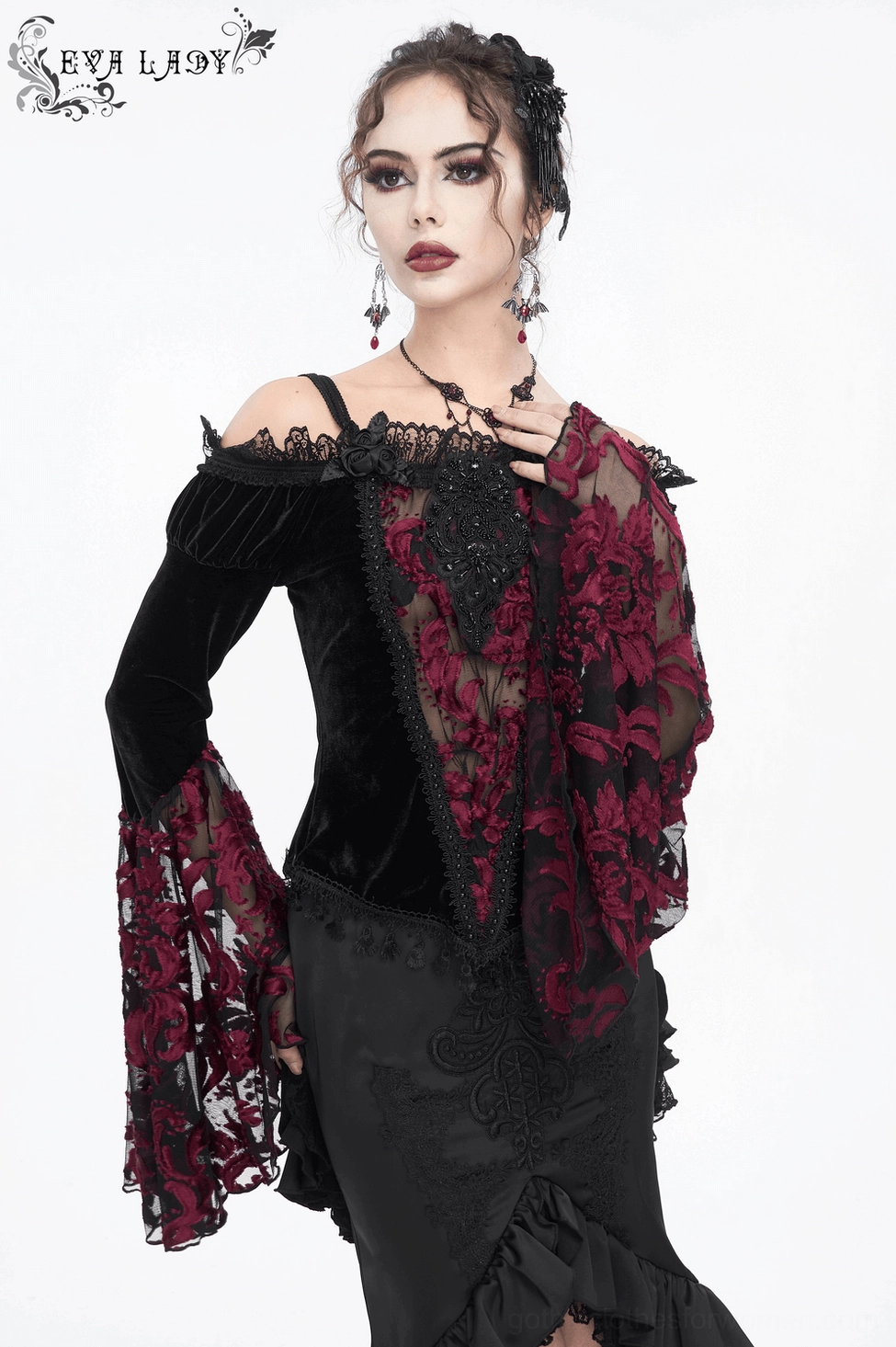 Gothic black velvet off-shoulder top detail showing lace sleeve design and burgundy embellishments
